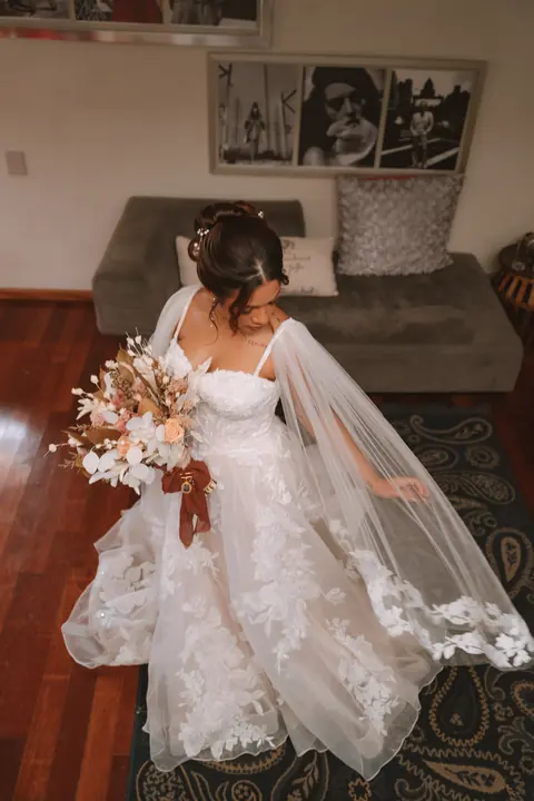 Novia mirando su vestido y su ramo